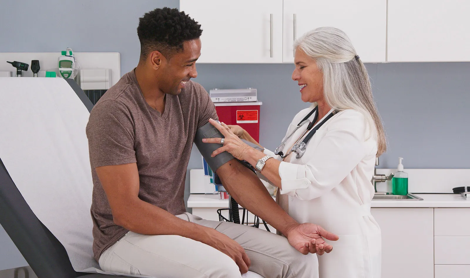 Nurse fits patient with blood pressure cuff