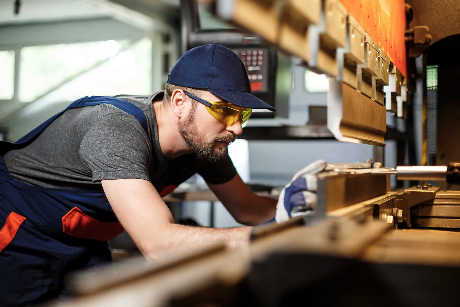 Young carpenter cuts wood