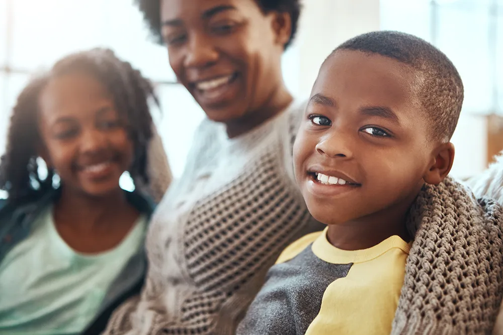Young family hugged by mother