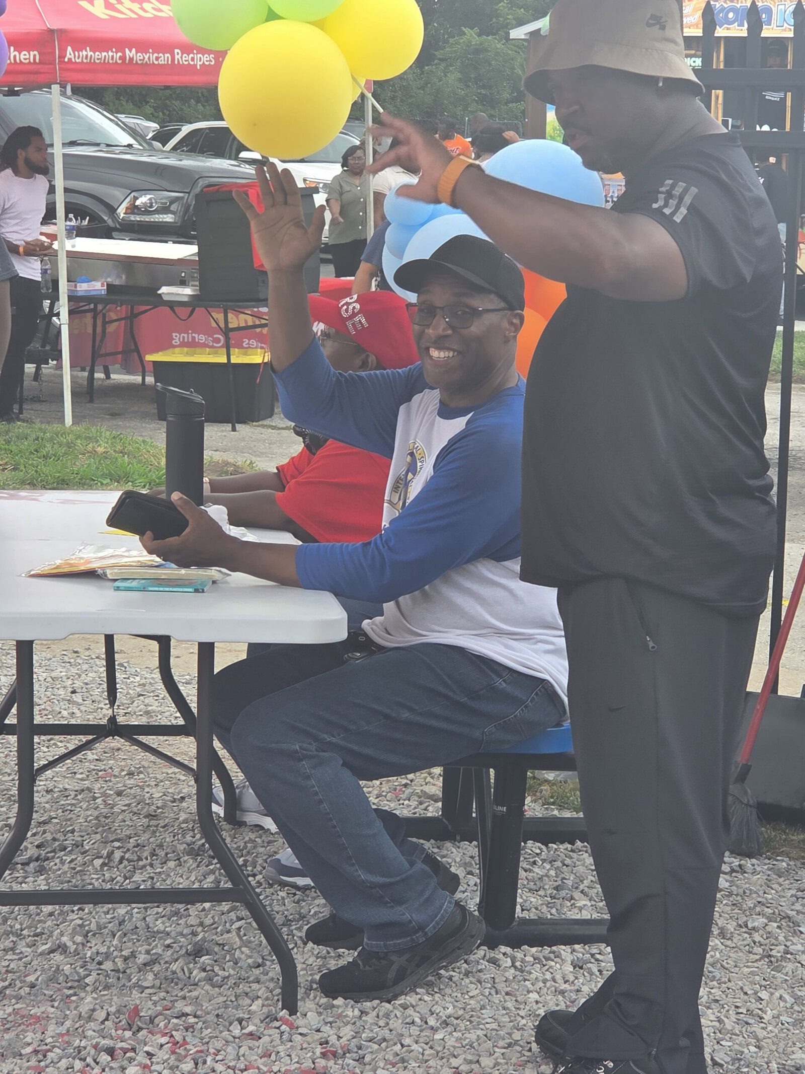 Two community members connecting at an outdoor MiHIA-area community event
