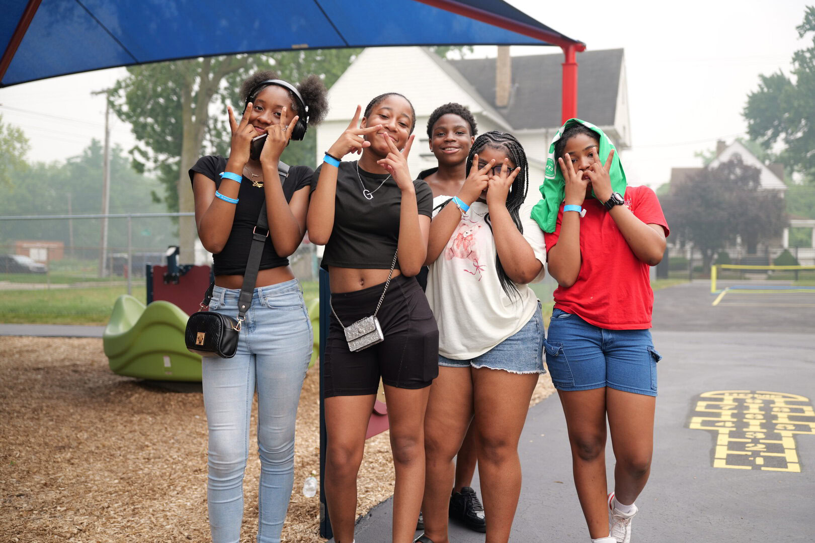 A group of young community members smiling together outdoors
